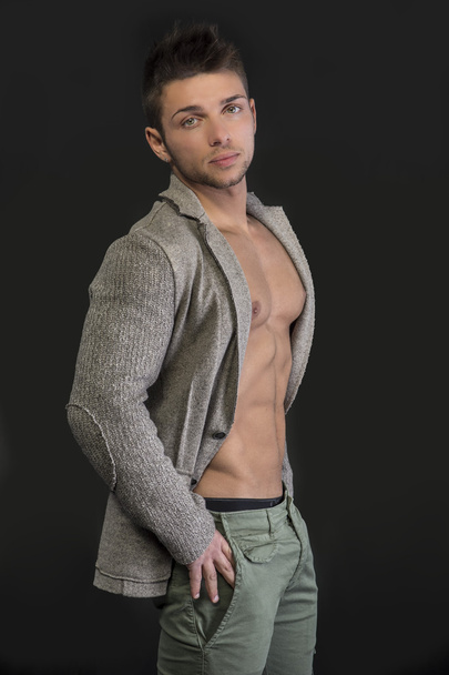Profile of young man with open jacket on muscular torso - Foto, imagen