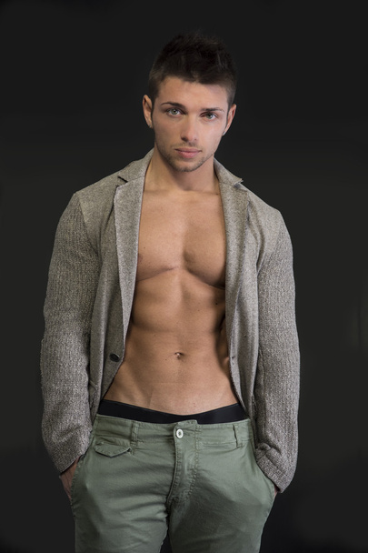 Muscular young man with open cardigan on naked torso - Photo, image