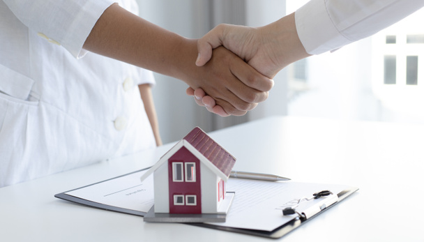 Property manager Shake hands with congratulations on the customers who bought the house with insurance, Hand shake, Success and congratulations concept. - Photo, Image
