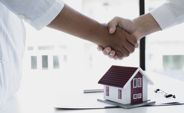Property manager Shake hands with congratulations on the customers who bought the house with insurance, Hand shake, Success and congratulations concept. - Photo, Image