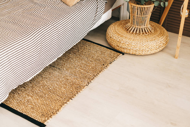 Eco-friendly bedside mat in modern bedroom interior. - 写真・画像