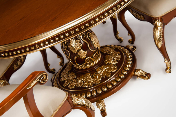 Luxury gold plated kitchen table and chairs in baroque style - Photo, Image