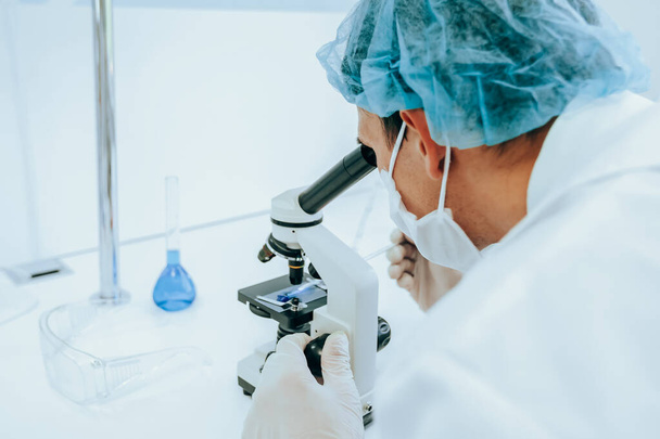 close up. scientist using a microscope in a modern laboratory. - Zdjęcie, obraz