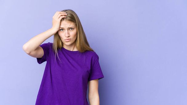 Young blonde woman isolated on purple background being shocked, she has remembered important meeting. - Fotografie, Obrázek