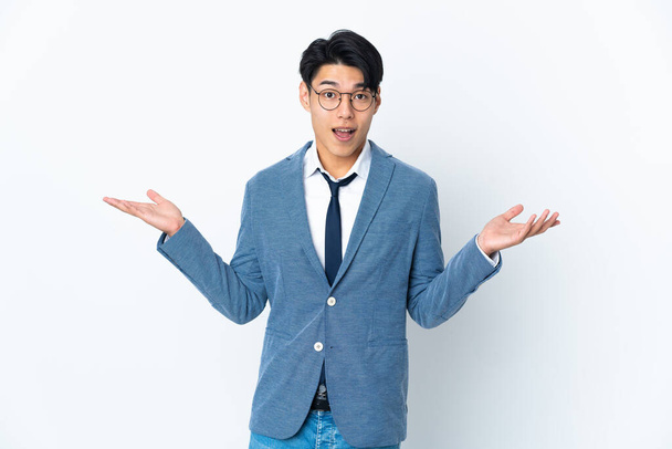 Young Chinese business man isolated on white background with shocked facial expression - Fotoğraf, Görsel