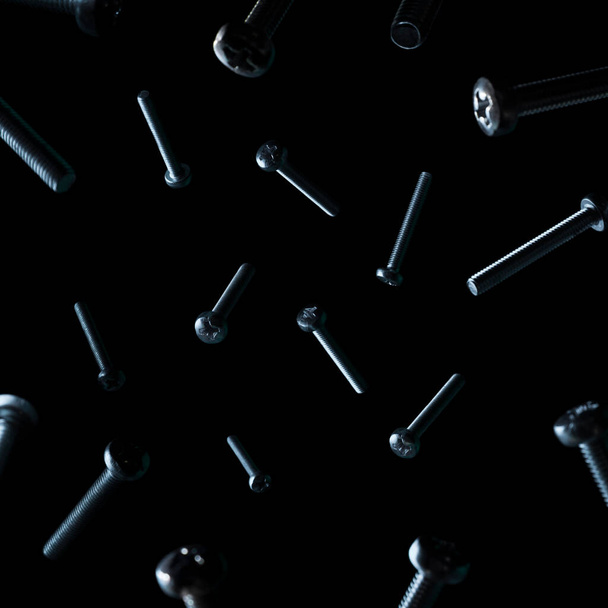 screws on a black background - Foto, Bild
