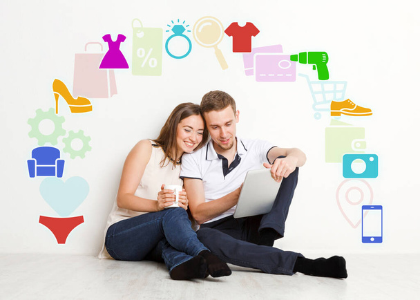 Online shopping. Millennial couple with tablet computer surrounded by different icons of household goods, collage - Photo, Image