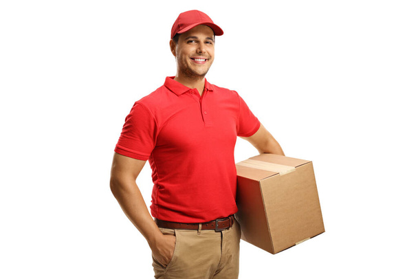 Male courier in a uniform holding  a box isolated on white background - Valokuva, kuva