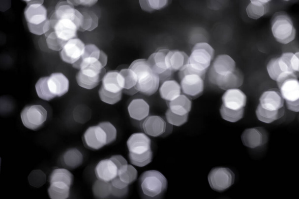 Blurred lights dark gray background. Abstract bokeh with soft light. Shiny festive christmas texture - Photo, Image