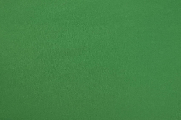 Green background with textured surface, fabric. - Photo, Image