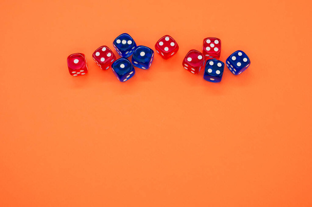 A top view of red and blue dice isolated on orange background - Foto, immagini
