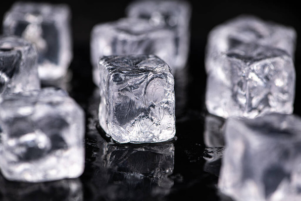 Ice Cubes on dark background as detailed close-up shot; selective focus - 写真・画像
