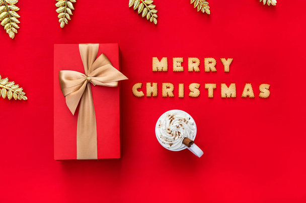 Christmas red background with Christmas gift and cookies decor. Top view with copy space. Minimalism. Merry Christmas. - Foto, Imagen