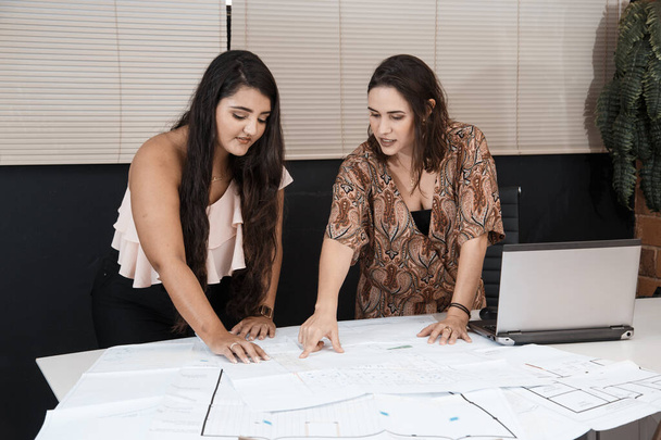 two young female architects working and their office. - Φωτογραφία, εικόνα
