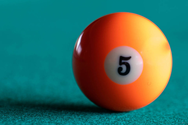 orange pool ball on green clothe - Photo, Image