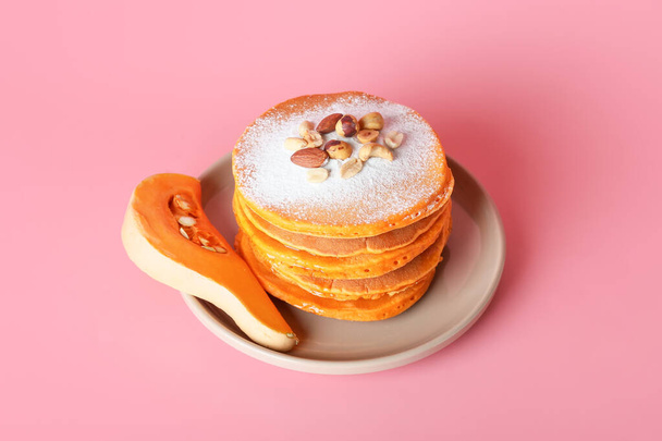 Tasty pumpkin pancakes on color background - Photo, Image