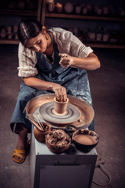 Charming pottery shows how to work with clay and pottery wheel. Restoration of forgotten pottery traditions. - Photo, Image
