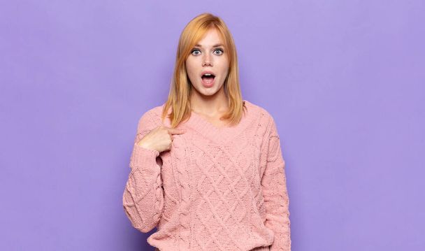 red head pretty woman looking shocked and surprised with mouth wide open, pointing to self - Фото, зображення