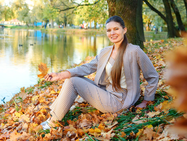 Outdoors portrait of colorful clothed gorgeous fall fashion girl. - Photo, Image