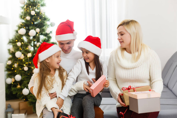 Happy family playing with Christmas gifts at home - Foto, Imagem