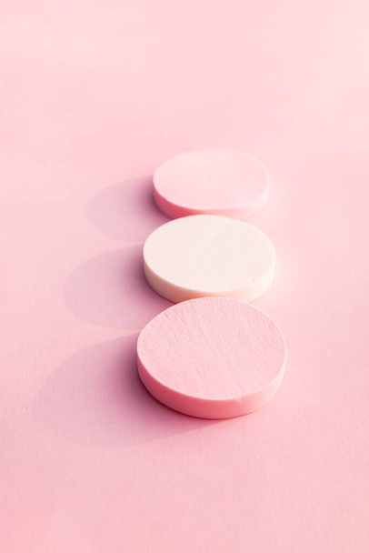 Kosmetische Schwämme in Pastellfarben auf sanftem rosa Hintergrund. - Foto, Bild