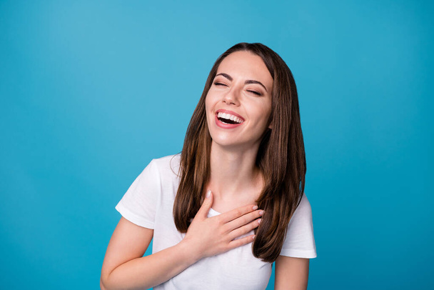 Photo of energetic excited girl listen her friend joking laughing touch hand chest wear good look clothes isolated over blue color background - Foto, immagini