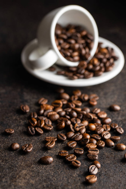 Roasted coffee beans on black table. - Foto, Bild