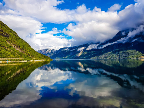 reflection of the sky and mountains in the blue water of the fjord - Eidfjord - Foto, immagini