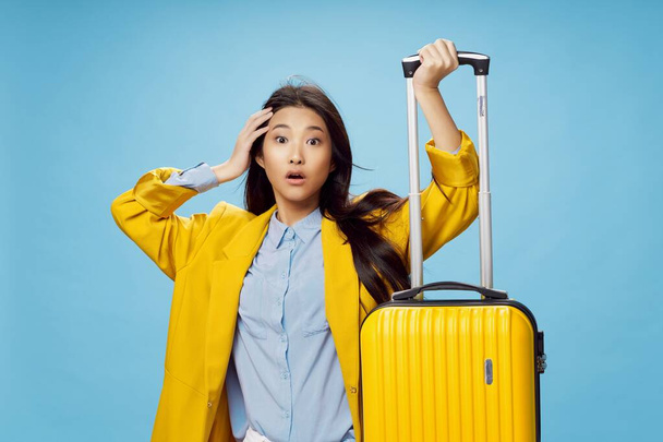 Mujer sorprendida con maleta amarilla vacaciones aeropuerto de pasajeros  - Foto, imagen