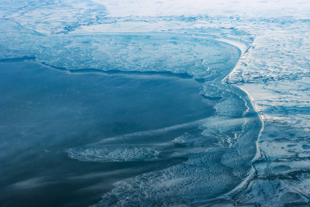 Sea coast with ice from a bird's eye view, winter landscape. - Zdjęcie, obraz