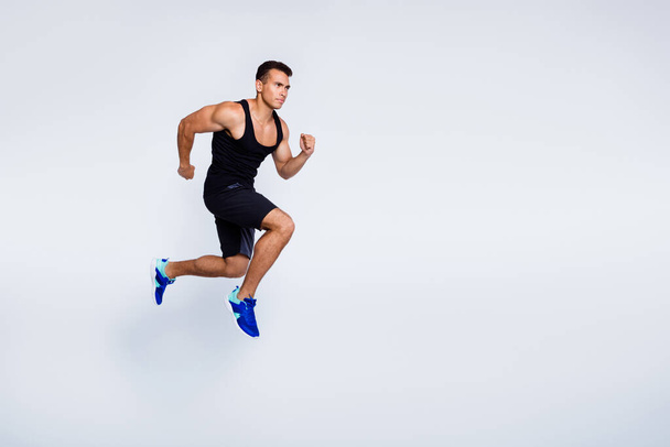 Full length body size view of his he nice attractive muscular focused purposeful guy jumping running jogging sprint distance isolated over light gray pastel color background - Foto, Imagem