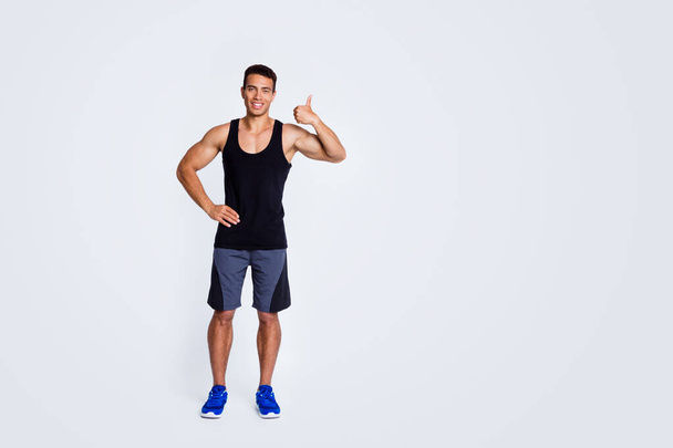 Full length body size view of his he nice attractive strong tall sportive cheerful muscular guy showing thumbup advert ad advertisement isolated over light gray pastel color background - Foto, Imagen