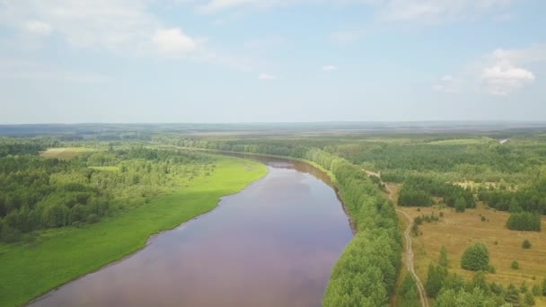 Beautiful autumn countryside nature landscape. Clip. Aerial view of mixed forest, green fields, beautiful suburb with a wide river and meadows. - Footage, Video