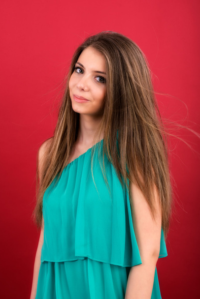 Portrait of beautiful woman on red background - Foto, afbeelding