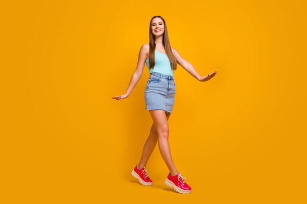 Full length body size view of her she nice-looking attractive lovely pretty cute cheerful glad straight-haired girl going isolated over bright vivid shine vibrant yellow color background - Foto, Bild