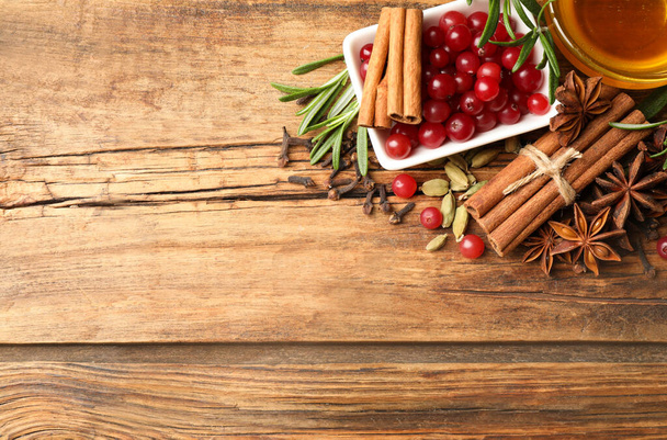 Flat lay composition with mulled wine ingredients on wooden table. Space for text - Fotoğraf, Görsel