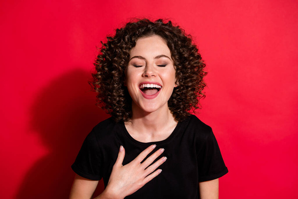 Close-up portrait of pretty cheerful wavy-haired girl laughing out loudly isolated over bright red color background - Foto, Imagen