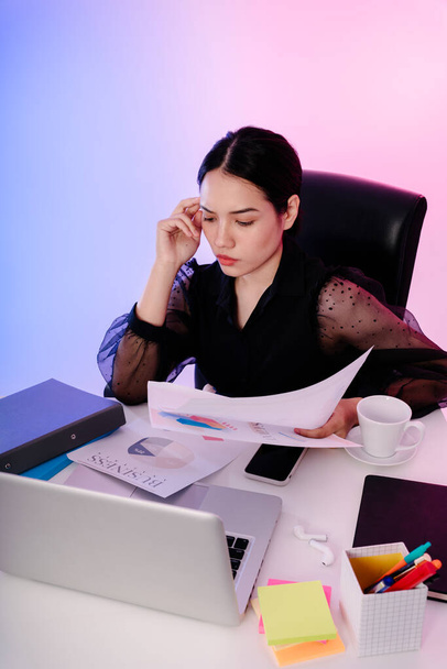 Asian businesswoman black hair reading document paper in office. - Foto, Imagen