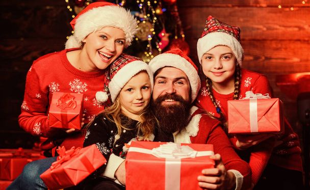 Christmas joy. Christmas tradition. Happy holidays. Parents and children opening christmas gifts. Cheerful family concept. Father Santa claus and mother little daughters christmas tree background - Foto, Imagen