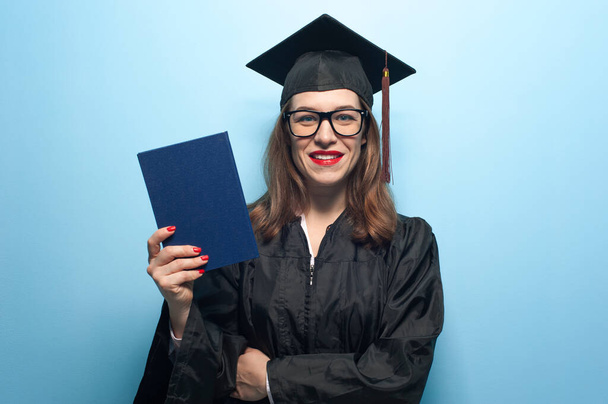 Graduate female student with stubble in eyeglasses wearing black mantle - Foto, afbeelding