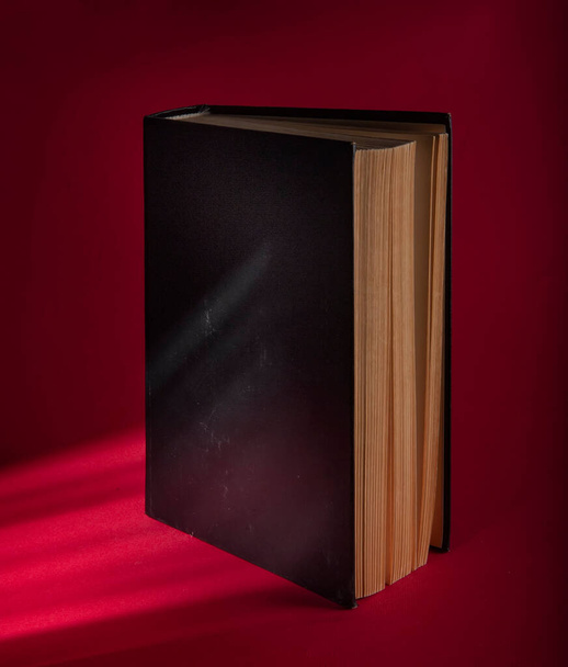 Old book on a crimson background - Photo, Image