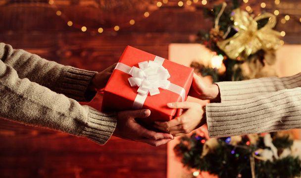 Giving and receiving. Delivery service. Hands holding gift box. Post service. Share with closest. Gift box in hands close up. Handover concept. Christmas wrapped gift with bow. Spread love around - Foto, Imagem