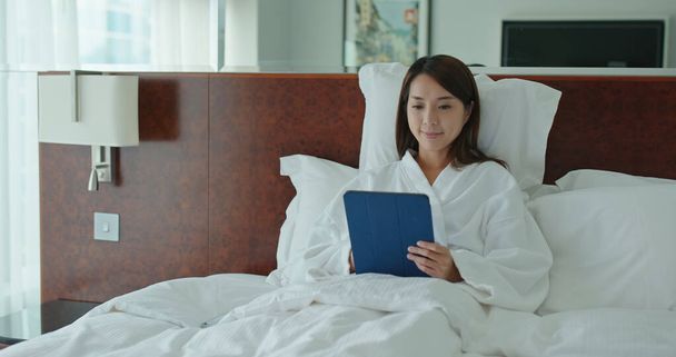 Woman work on tablet and sit on bed - Photo, Image