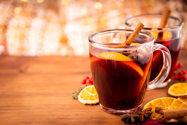 German tradition winter Christmas market new year holidays festival drink Gluhwein Mulled sweet hot warm red Wine with spices citrus aromatic cinnamon star anise  - Фото, изображение