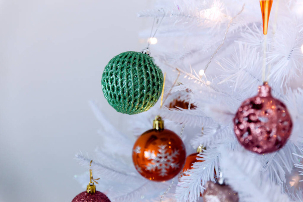 Luxury white Christmas tree with colorful toys and lights. Light white Christmas background. - Valokuva, kuva