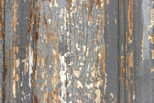 The surface of old wooden boards with peeling and weathered paint. - Фото, изображение