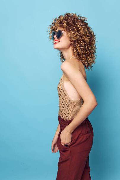 Emotional woman curly hair Smile red lips fashionable clothes  - Фото, изображение