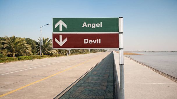 Straßenschild weist den Weg zum Engel gegen Teufel - Foto, Bild