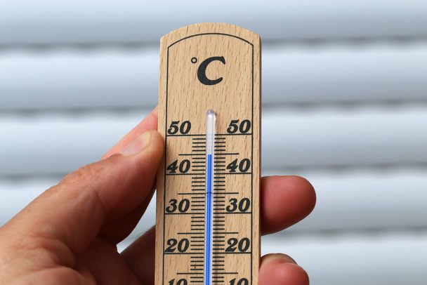 A person's hand holding a thermometer indicating a hot summer - Zdjęcie, obraz