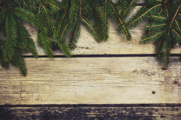 Christmas tree branches on wooden table. Xmas background - Foto, immagini